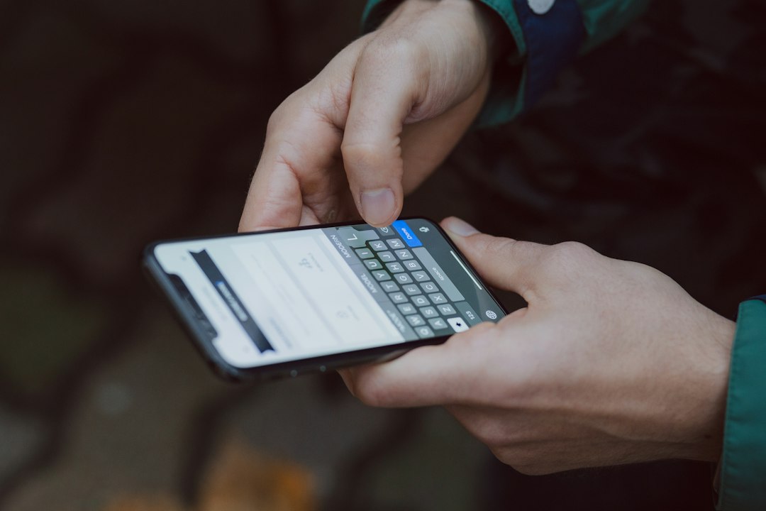 Person using a smartphone, illustrating scam calls, text messages, and online fraud warnings